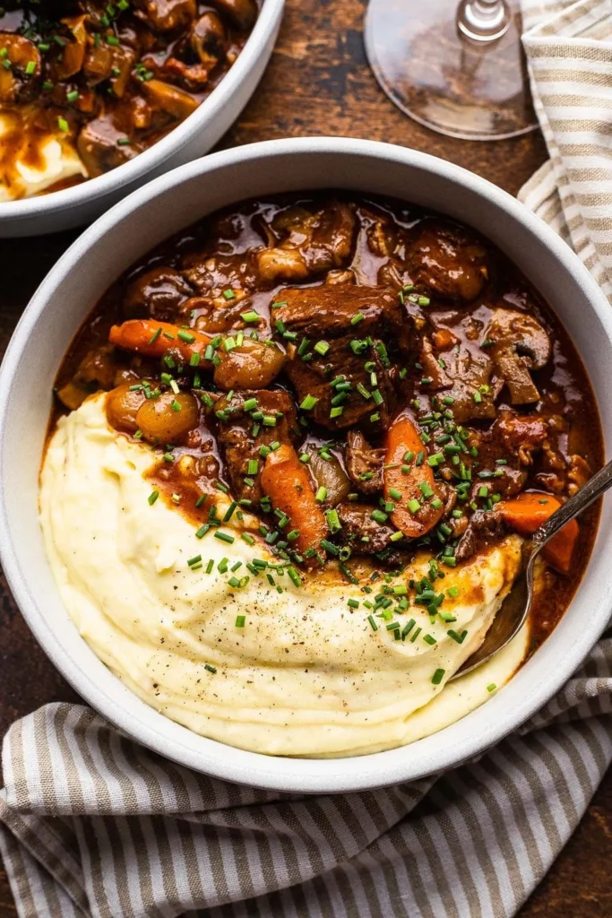 Delicious bowl of classic Beef Bourguignon garnished with herbs