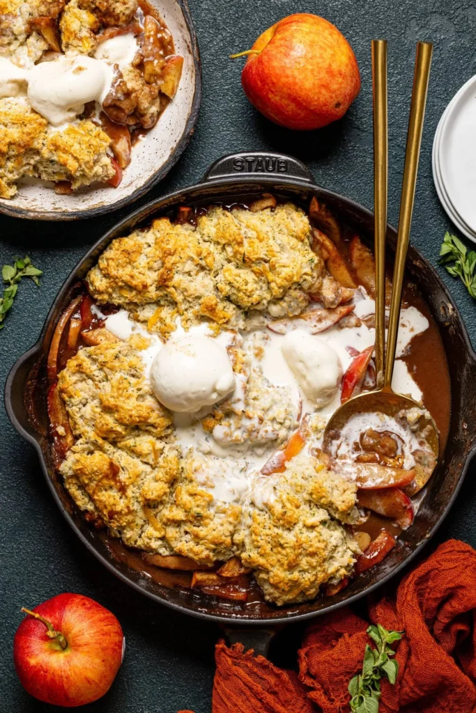 Dairy-free apple cobbler with cheddar herb biscuits served in a rustic dish