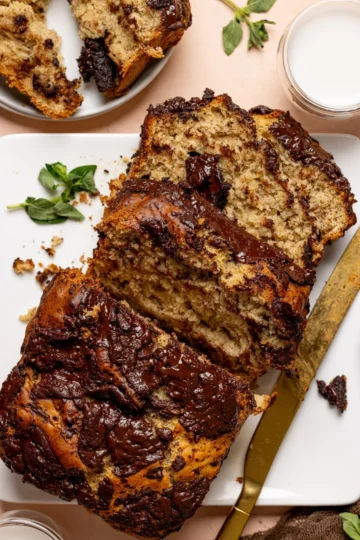 Vegan Maple Chocolate Chip Banana Bread baked and sliced on a wooden board